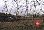 Image of view through barbed wire at airbase operations Vietnam, 1967, second 25 stock footage video 65675061936