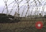 Image of view through barbed wire at airbase operations Vietnam, 1967, second 26 stock footage video 65675061936