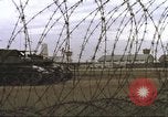 Image of view through barbed wire at airbase operations Vietnam, 1967, second 27 stock footage video 65675061936