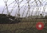 Image of view through barbed wire at airbase operations Vietnam, 1967, second 28 stock footage video 65675061936