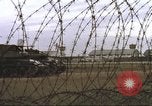 Image of view through barbed wire at airbase operations Vietnam, 1967, second 29 stock footage video 65675061936
