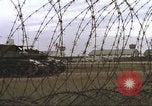 Image of view through barbed wire at airbase operations Vietnam, 1967, second 30 stock footage video 65675061936