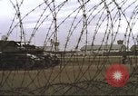 Image of view through barbed wire at airbase operations Vietnam, 1967, second 31 stock footage video 65675061936