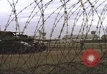Image of view through barbed wire at airbase operations Vietnam, 1967, second 32 stock footage video 65675061936
