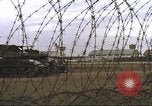 Image of view through barbed wire at airbase operations Vietnam, 1967, second 34 stock footage video 65675061936