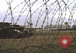 Image of view through barbed wire at airbase operations Vietnam, 1967, second 35 stock footage video 65675061936