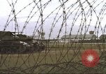 Image of view through barbed wire at airbase operations Vietnam, 1967, second 36 stock footage video 65675061936
