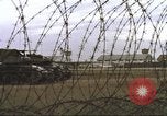 Image of view through barbed wire at airbase operations Vietnam, 1967, second 37 stock footage video 65675061936