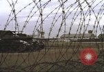 Image of view through barbed wire at airbase operations Vietnam, 1967, second 38 stock footage video 65675061936