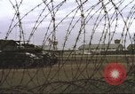 Image of view through barbed wire at airbase operations Vietnam, 1967, second 39 stock footage video 65675061936