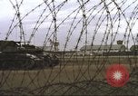 Image of view through barbed wire at airbase operations Vietnam, 1967, second 41 stock footage video 65675061936