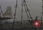 Image of view through barbed wire at airbase operations Vietnam, 1967, second 43 stock footage video 65675061936