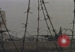 Image of view through barbed wire at airbase operations Vietnam, 1967, second 44 stock footage video 65675061936