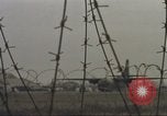 Image of view through barbed wire at airbase operations Vietnam, 1967, second 45 stock footage video 65675061936
