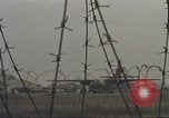 Image of view through barbed wire at airbase operations Vietnam, 1967, second 46 stock footage video 65675061936