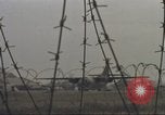 Image of view through barbed wire at airbase operations Vietnam, 1967, second 47 stock footage video 65675061936