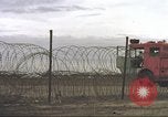 Image of view through barbed wire at airbase operations Vietnam, 1967, second 48 stock footage video 65675061936