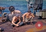 Image of U.S. Coast Guardsmen perform maintenance on LST  Iwo Jima, 1945, second 15 stock footage video 65675062154