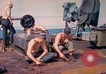 Image of U.S. Coast Guardsmen perform maintenance on LST  Iwo Jima, 1945, second 18 stock footage video 65675062154