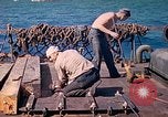 Image of U.S. Coast Guardsmen perform maintenance on LST  Iwo Jima, 1945, second 39 stock footage video 65675062154