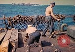 Image of U.S. Coast Guardsmen perform maintenance on LST  Iwo Jima, 1945, second 50 stock footage video 65675062154