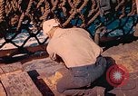 Image of U.S. Coast Guardsmen perform maintenance on LST  Iwo Jima, 1945, second 56 stock footage video 65675062154