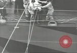 Image of Transferring wounded between ships on Stokes stretcher Mariana Islands, 1944, second 35 stock footage video 65675062231