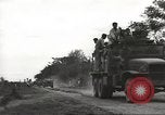 Image of Americans rescued from Japanese prison camp ride in trucks Guimba Nueva Ecija Philippines, 1945, second 4 stock footage video 65675062322