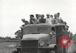 Image of Americans rescued from Japanese prison camp ride in trucks Guimba Nueva Ecija Philippines, 1945, second 42 stock footage video 65675062322