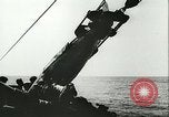 Image of German submarine U-564 reloads torpedo at sea Atlantic Ocean, 1942, second 60 stock footage video 65675062706