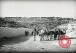 Standbild kleiner Junge zu Fuß und mit Kamelen Amman Transjordan, 1945, aus Sekunde 7 historischem Filmmaterial Videoclip 65675062976