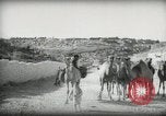 Standbild kleiner Junge zu Fuß und mit Kamelen Amman Transjordan, 1945, aus Sekunde 15 historischem Filmmaterial Videoclip 65675062976
