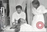 Immagine di Salone di bellezza per donne afroamericane ad Harlem New York City USA, 1940, secondo 48 filmato di repertorio 65675063284