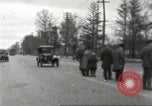 Image of An automobile almost hits pedestrians in center of a road Michigan United States USA, 1916, second 14 stock footage video 65675064462