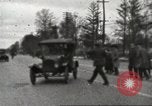 Image of An automobile almost hits pedestrians in center of a road Michigan United States USA, 1916, second 17 stock footage video 65675064462