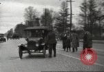 Image of An automobile almost hits pedestrians in center of a road Michigan United States USA, 1916, second 18 stock footage video 65675064462