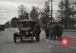 Image of An automobile almost hits pedestrians in center of a road Michigan United States USA, 1916, second 19 stock footage video 65675064462