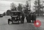 Image of An automobile almost hits pedestrians in center of a road Michigan United States USA, 1916, second 20 stock footage video 65675064462