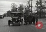 Image of An automobile almost hits pedestrians in center of a road Michigan United States USA, 1916, second 21 stock footage video 65675064462