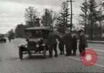 Image of An automobile almost hits pedestrians in center of a road Michigan United States USA, 1916, second 22 stock footage video 65675064462