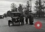 Image of An automobile almost hits pedestrians in center of a road Michigan United States USA, 1916, second 23 stock footage video 65675064462