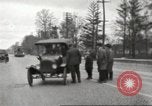 Image of An automobile almost hits pedestrians in center of a road Michigan United States USA, 1916, second 24 stock footage video 65675064462