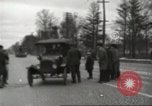 Image of An automobile almost hits pedestrians in center of a road Michigan United States USA, 1916, second 25 stock footage video 65675064462