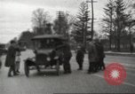 Image of An automobile almost hits pedestrians in center of a road Michigan United States USA, 1916, second 26 stock footage video 65675064462