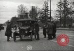 Image of An automobile almost hits pedestrians in center of a road Michigan United States USA, 1916, second 27 stock footage video 65675064462