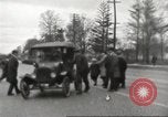 Image of An automobile almost hits pedestrians in center of a road Michigan United States USA, 1916, second 28 stock footage video 65675064462