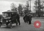 Image of An automobile almost hits pedestrians in center of a road Michigan United States USA, 1916, second 29 stock footage video 65675064462