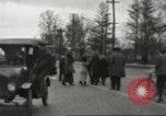 Image of An automobile almost hits pedestrians in center of a road Michigan United States USA, 1916, second 30 stock footage video 65675064462