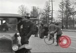 Image of An automobile almost hits pedestrians in center of a road Michigan United States USA, 1916, second 32 stock footage video 65675064462