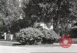 Image of An automobile almost hits pedestrians in center of a road Michigan United States USA, 1916, second 35 stock footage video 65675064462